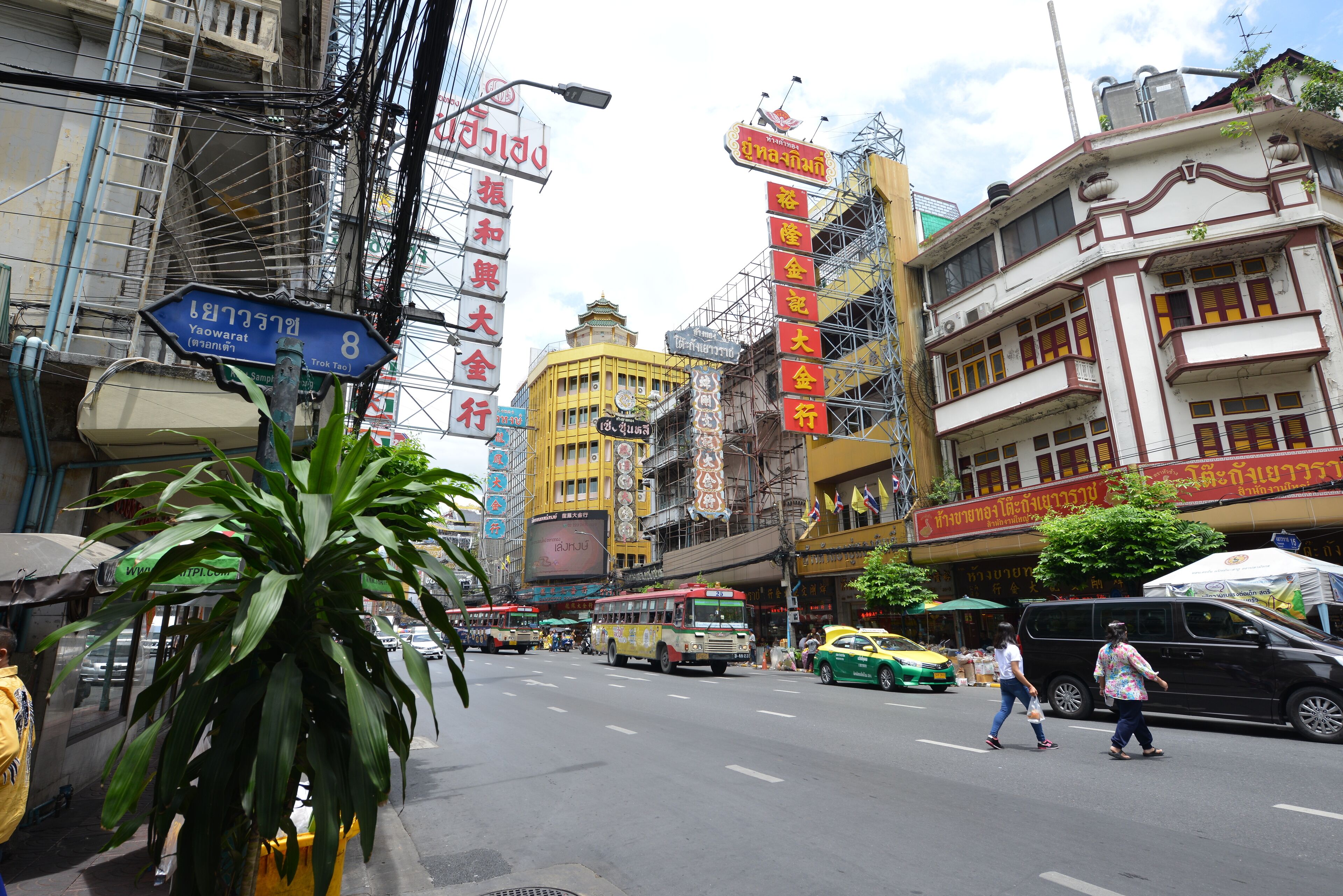 A busy urban street with buildings, traffic, and pedestrians.