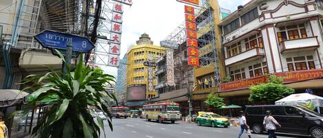 A busy urban street with buildings, traffic, and pedestrians.