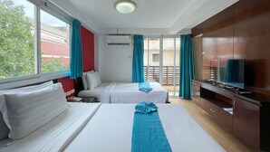 A hotel room with two beds, a TV, and a balcony with curtains. - Arawana Express Chinatown (Bangkok)