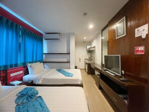 A hotel room with two beds, a TV, a desk, a mirror, and a no-smoking sign. - Arawana Express Chinatown (Bangkok)