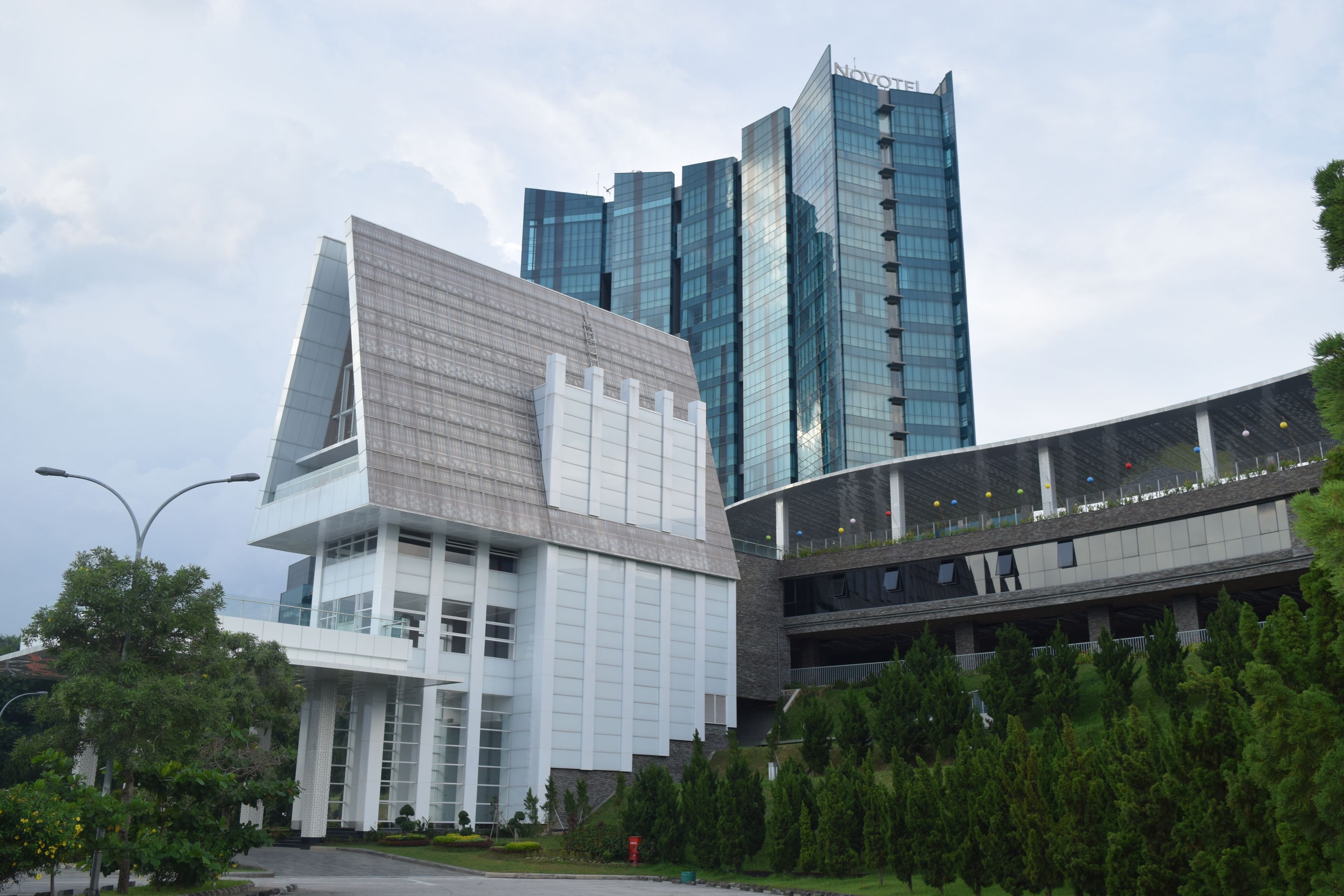 A modern building with a prominent glass facade and a unique angular design.