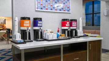 A coffee station with four dispensers labeled 'Light Roast,' 'Dark Roast,' 'Hot Water,' and 'Decaf Roast.'