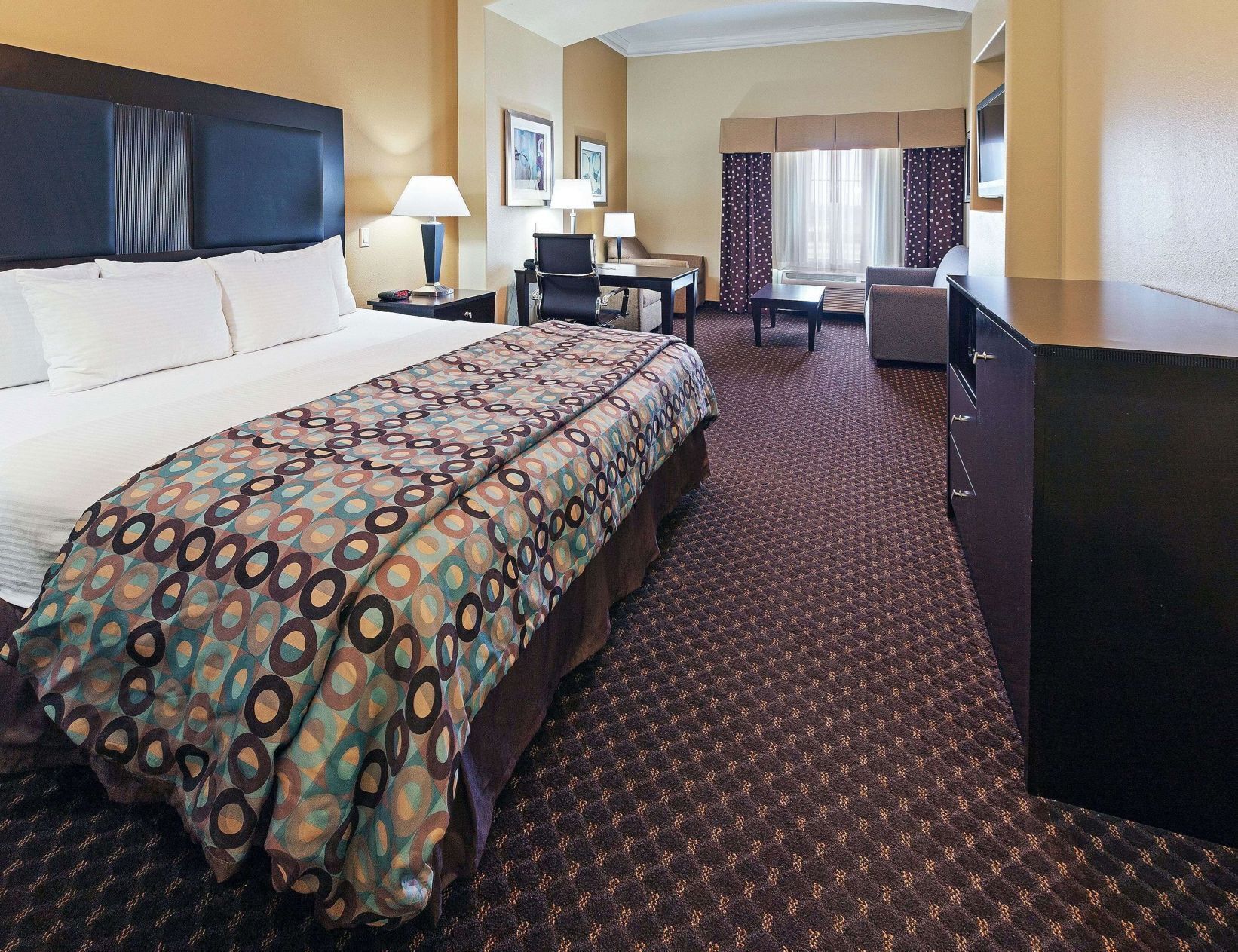 Premium bedding, desk, laptop workspace, blackout curtains