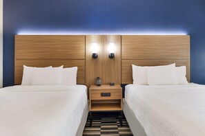 Premium bedding, desk, laptop workspace, blackout drapes