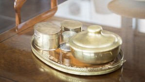 A dining table with a tray of silverware and a covered pot. - Rome Airport Hotel Fiumicino (Fiumicino)