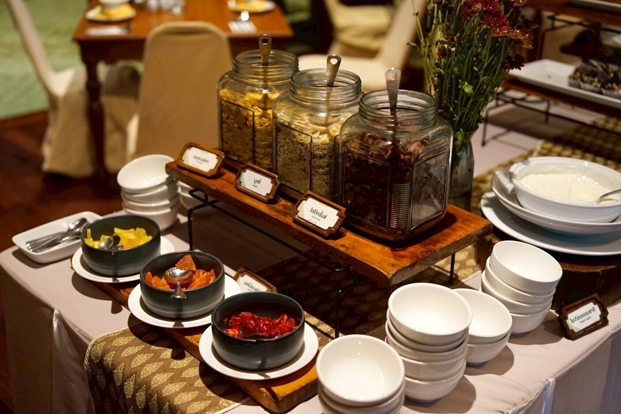 A buffet setup with various food items and labeled containers.