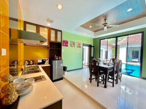 Fridge, electric kettle, paper towels, dining tables