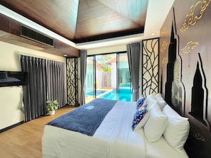 A bedroom with a large bed, a view of a swimming pool, and a modern design with wooden ceiling and decorative wall panels. - Kana Bay Villa Ao Nang (Krabi)