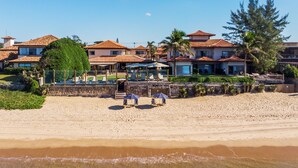 A beachfront property with multiple villas, a pool area, and a sandy beach. - Villa Rasa (Búzios)