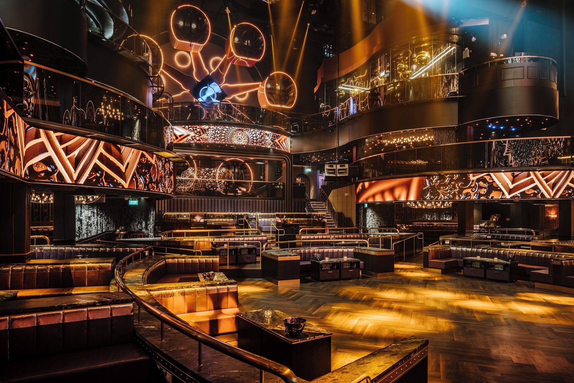 A multi-level bar area with tiered seating and a central stage.