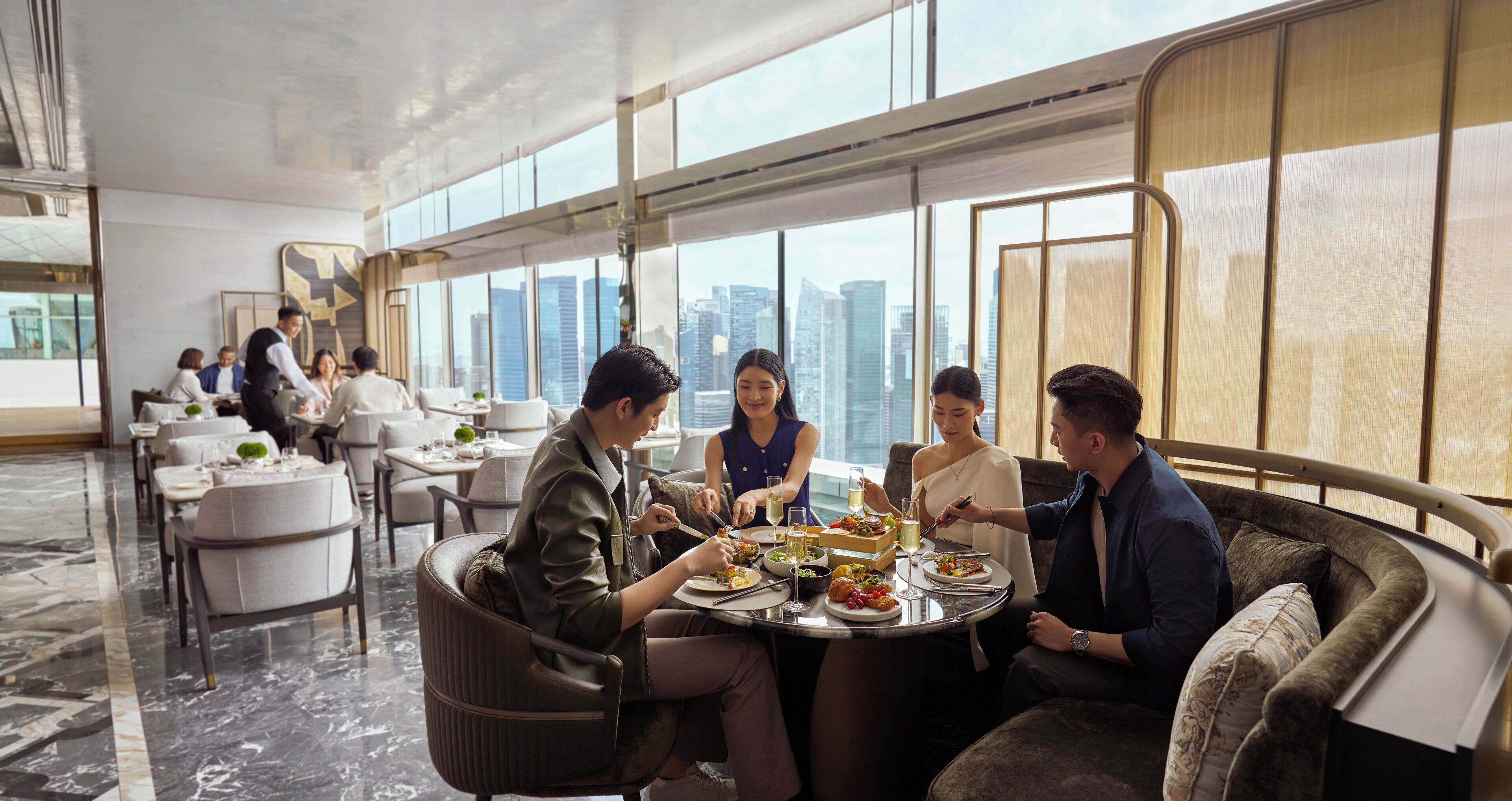 A modern dining area with a city view, marble flooring, and contemporary furniture.