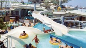 A cruise ship with a water park, including a wave pool and a Ferris wheel. - Comfort Suites Near City of Industry - Los Angeles (La Puente)