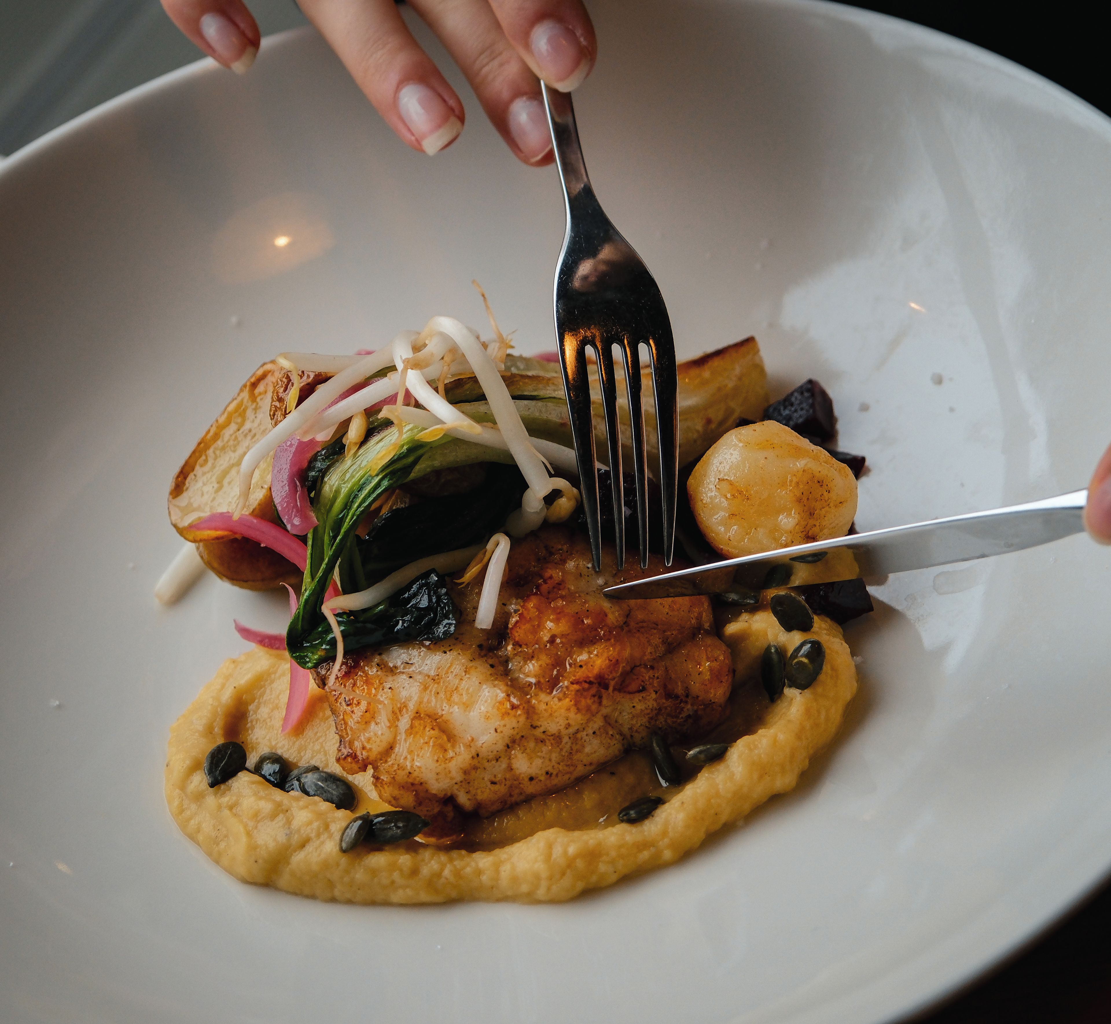 A plate of food with a fork and knife.