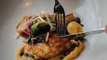 A plate of food with a fork and knife.