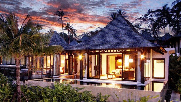A resort with multiple overwater bungalows, a swimming pool, and lush tropical vegetation. - The Vijitt Resort Phuket (Rawai)