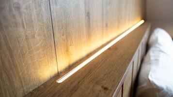 A wooden headboard with a built-in light strip.