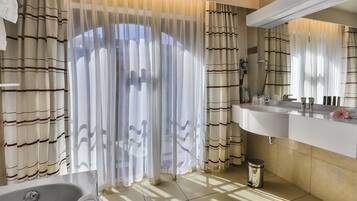 Un baño con bañera, lavamanos e inodoro.