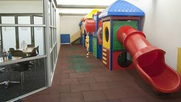 Children can play on the slide, climb the structure, and explore the playhouse in this vibrant play area.