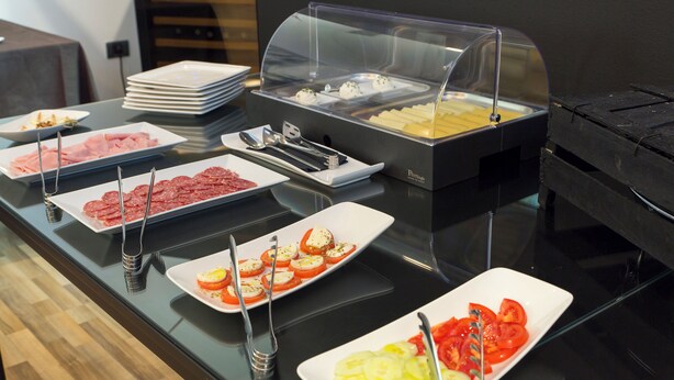 A buffet with various food options including sliced meats, cheeses, and vegetables. - Hotel Villa Annette (Rabac)