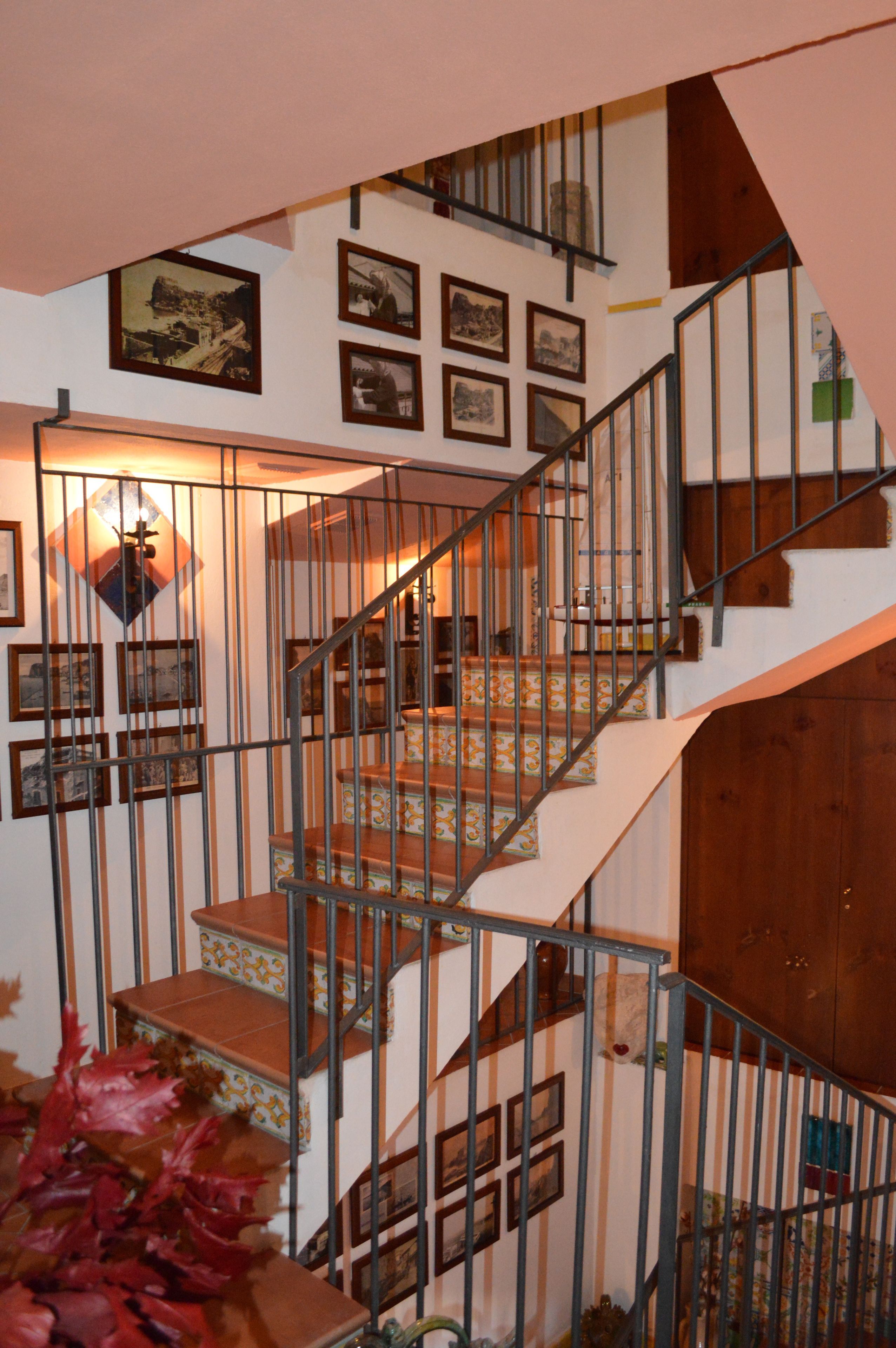 A staircase with multiple steps, metal railings, and a wooden door at the bottom.