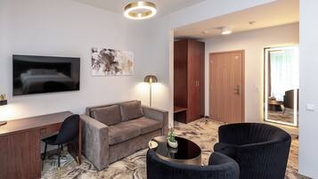 A modern living room with a sofa, a desk, a chair, and a coffee table.
