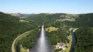 A conical structure with a river and greenery in the background.