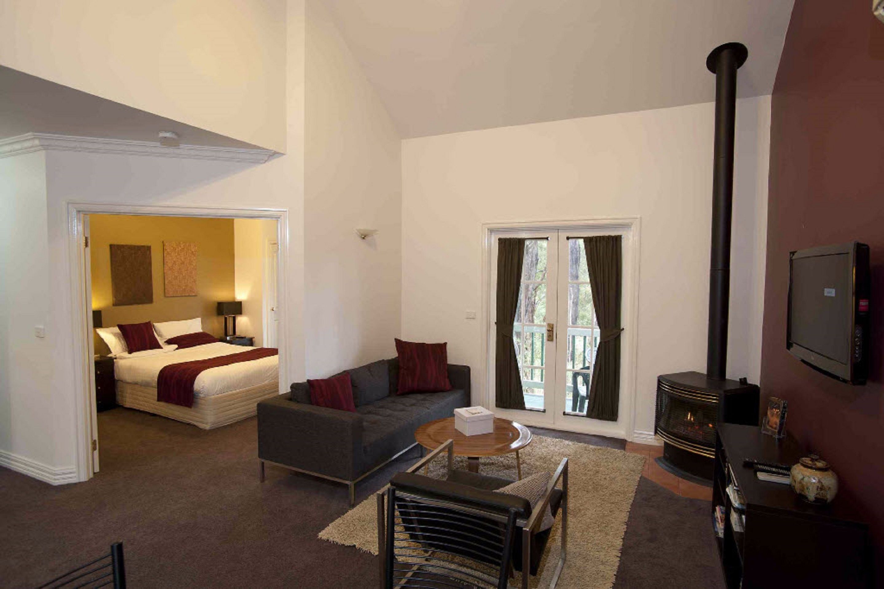  Queen Spa Villa | Living area | Flat-screen TV, fireplace, DVD player, iPod dock