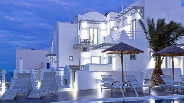 A modern hotel with a pool, white architecture, and lounge chairs. - Callia Retreat Adults Only (Santorini)