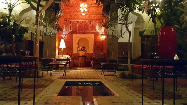 A traditional interior with a central fountain, seating areas, and ornate decor. - Riad Jenaï Demeures du Maroc (Marrakech)