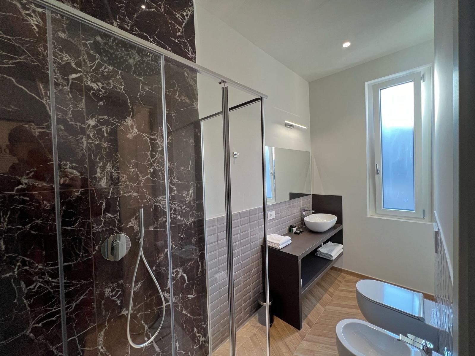 superior triple room | bathroom | shower, rainfall showerhead, free toiletries, hair dryer