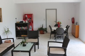 A compact living space with a dining area, a bookshelf, and a potted plant. - Alkion (Apokoronas)