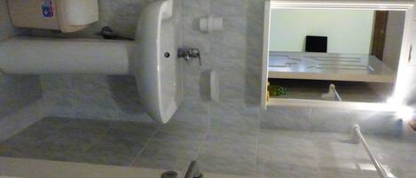 A bathroom with a bathtub, a sink, and a toilet.