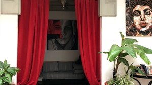 A doorway with red curtains, a hanging light fixture, and potted plants. - Riad Dar Nabila (Marrakech)