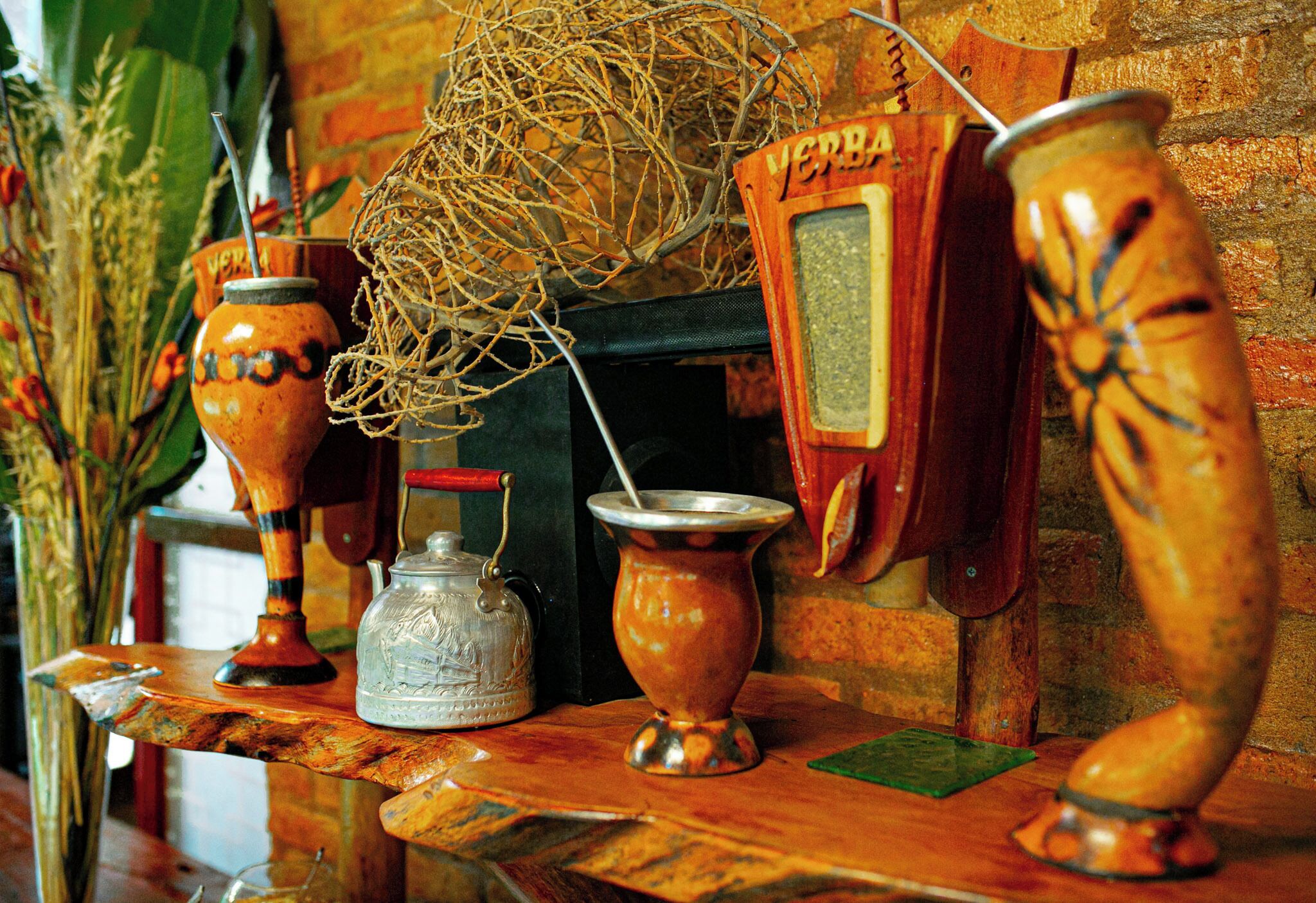 A shelf with various ceramic items, including a teapot, a jug, and a decorative vase.