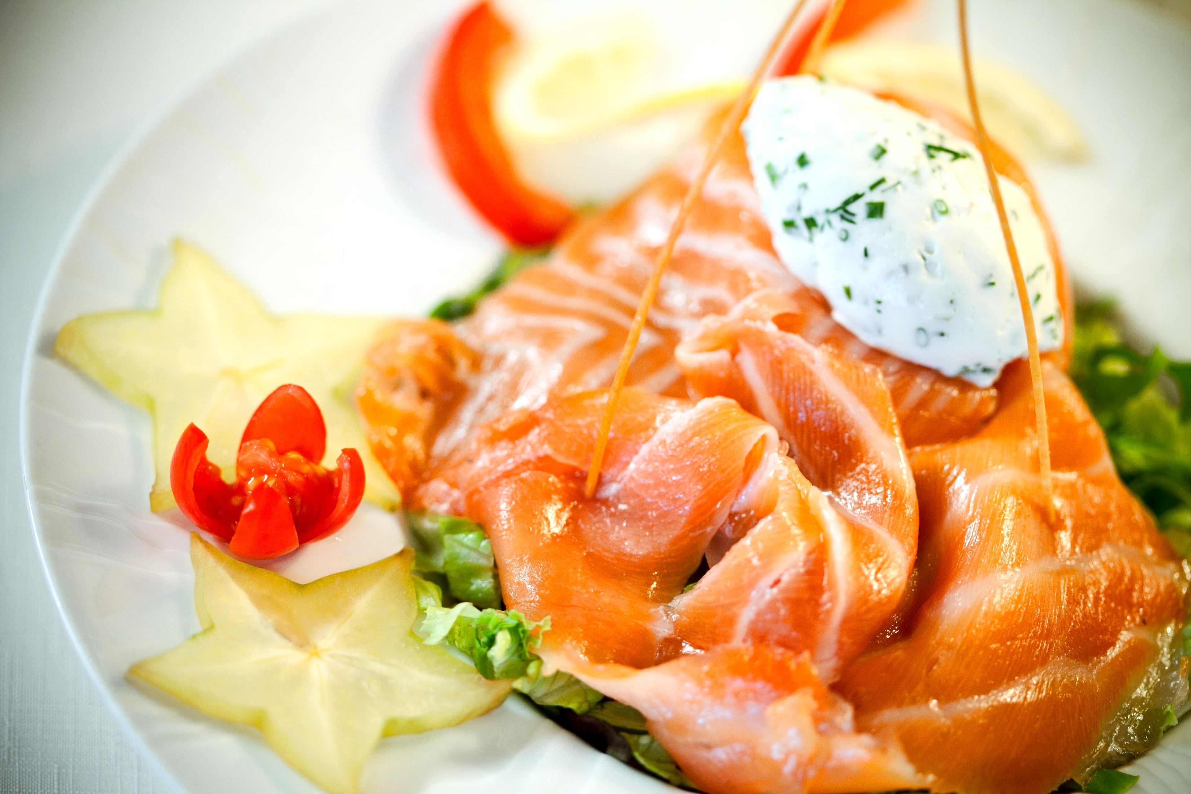 A plate of smoked salmon with garnishes.