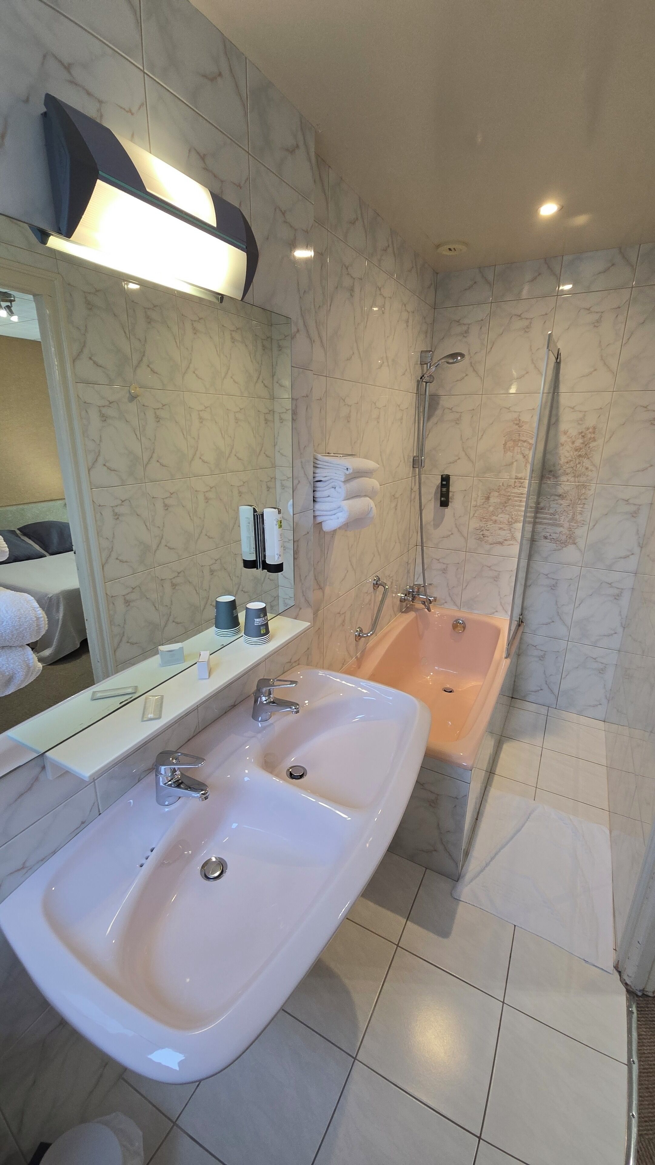 A bathroom with two sinks, a bathtub, and a shower.