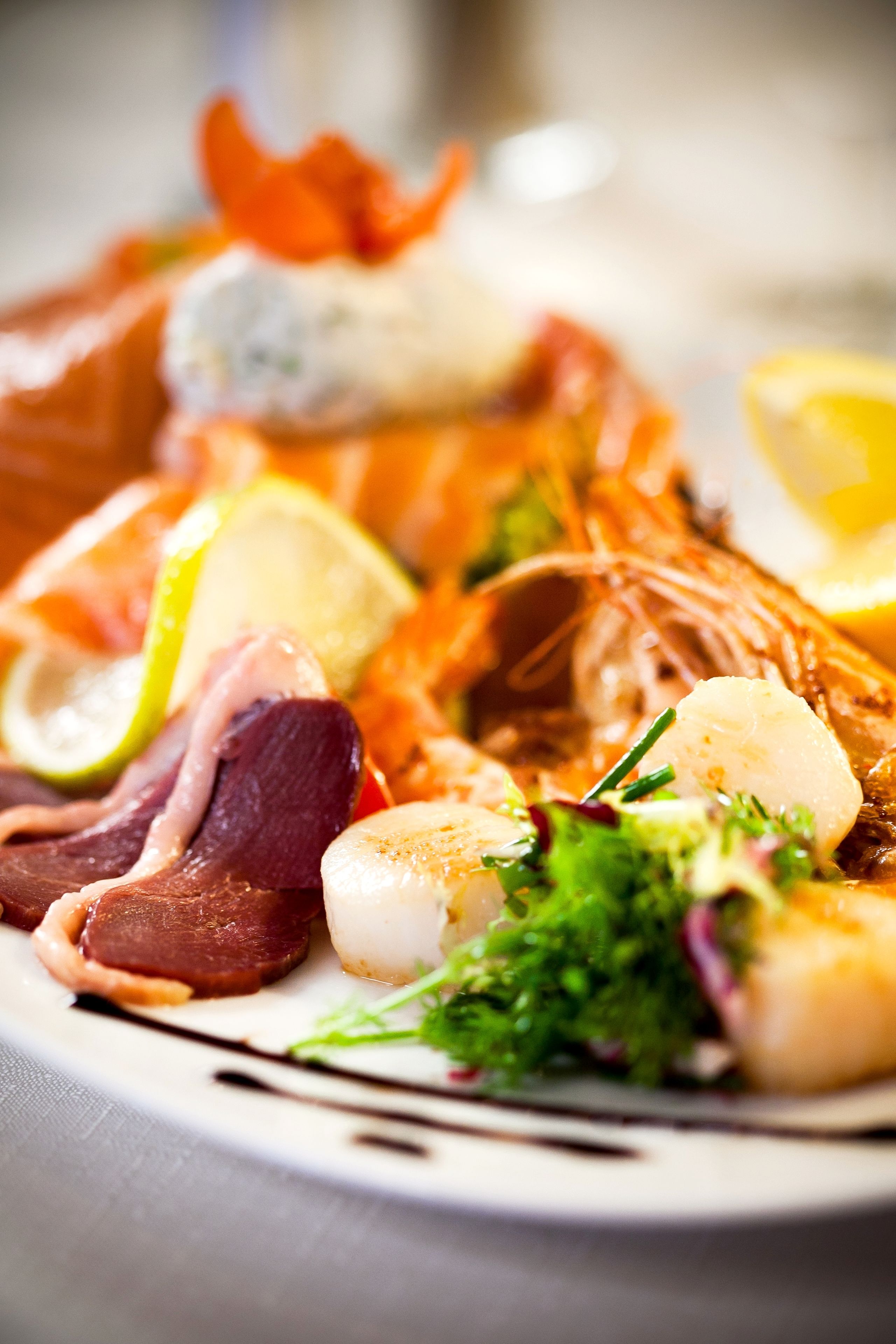 A seafood platter with various types of fish and garnishes.