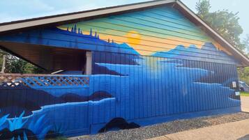 A building with a mural of a mountain landscape on its side.