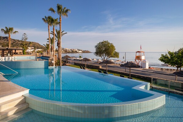 Indoor pool, outdoor pool, open 10 AM to 7 PM, pool umbrellas