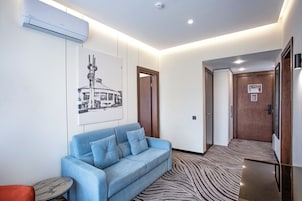 Premium Quadruple Room | Living area | 42-inch TV with cable channels