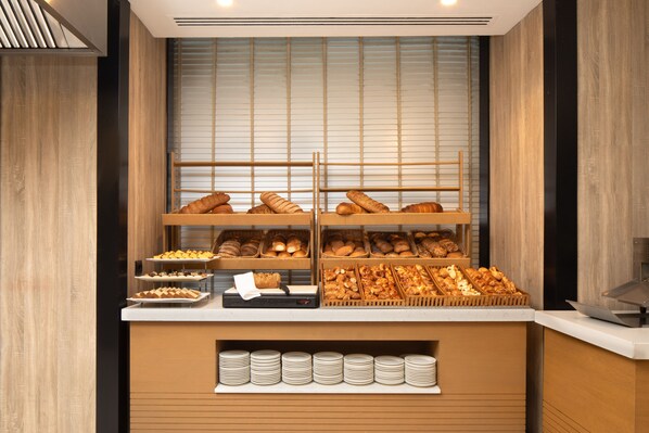 A bakery display with various baked goods and plates.