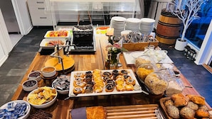 A buffet table with various food items, including pastries, breads, and desserts. - Dolphin Hotel Herning (Herning)