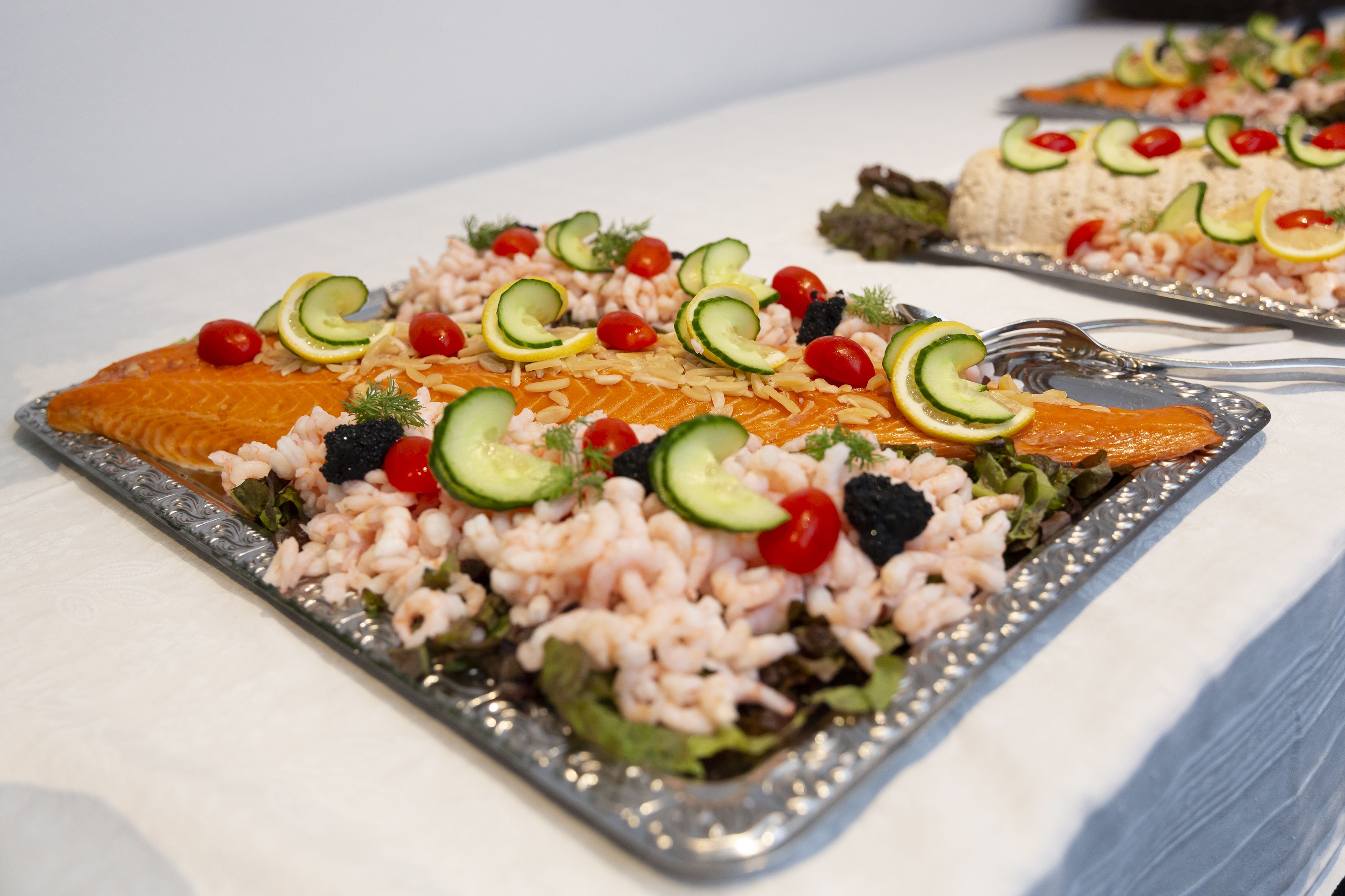 A plated meal with salmon, rice, and vegetables.