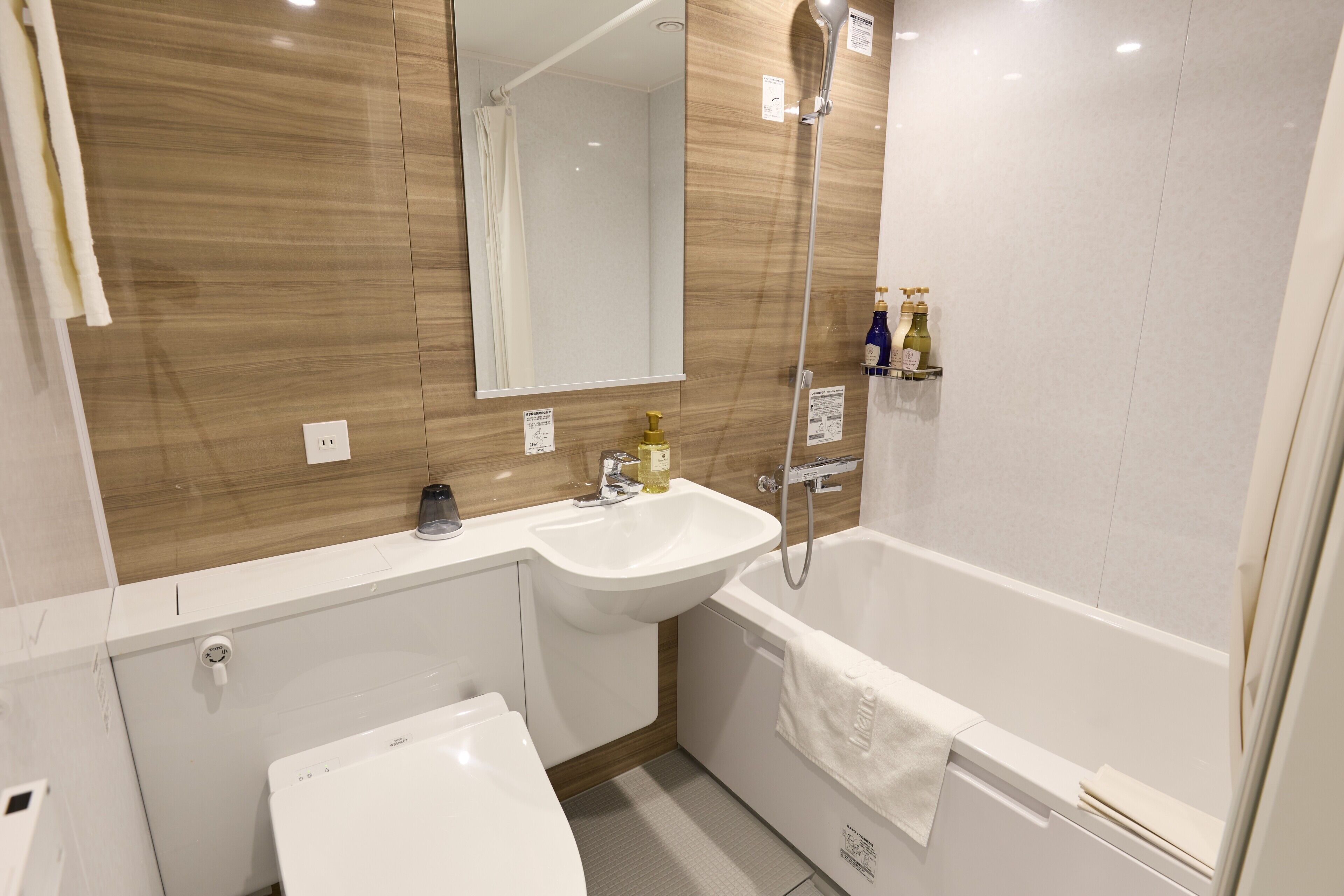 A modern bathroom with a sink, toilet, and bathtub.