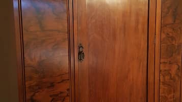 A large wooden wardrobe with ornate carvings on the doors and handles.