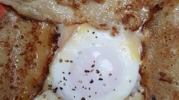 A close-up of a breakfast dish with a poached egg on toast.