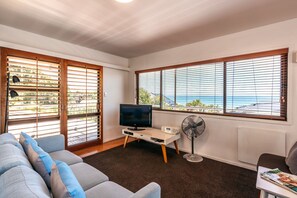 Two Bedroom Apartment with Ocean View | Living room | 30-inch flat-screen TV with satellite channels, TV - Onetangi Beach Apartments (Waiheke Island)