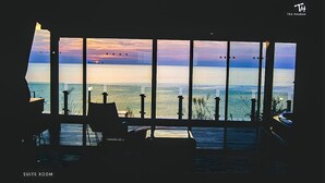 A suite room with a large window overlooking a body of water and a sunset. - The Houben - Adult Only (Ko Lanta)