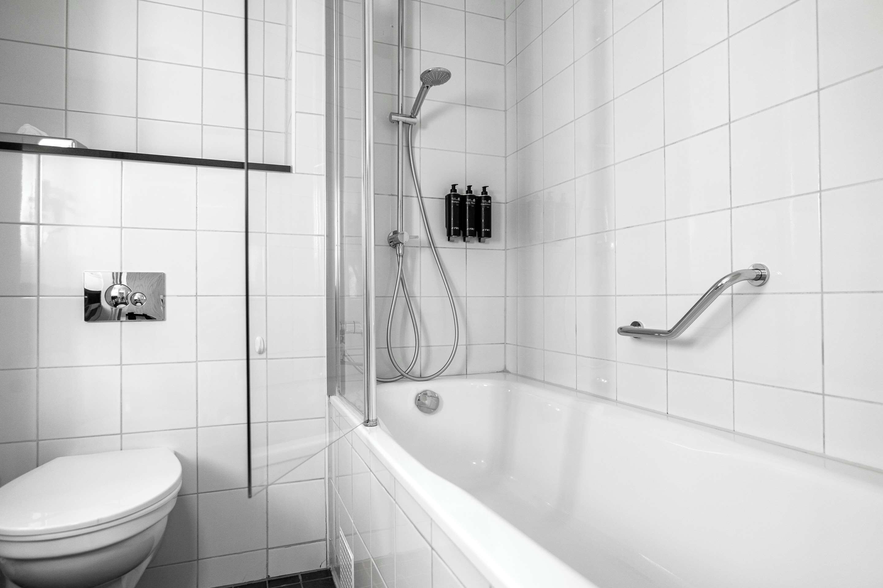 junior suite, 1 king bed, non smoking (separate living room) | bathroom | rainfall showerhead, eco-friendly toiletries, hair dryer, towels