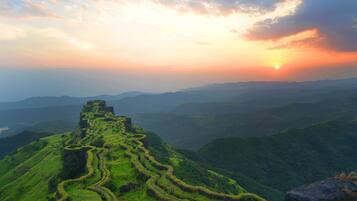A terraced landscape with a clear view of the horizon and distant mountains.